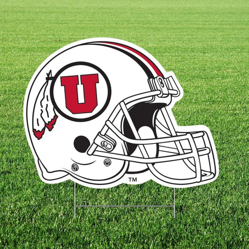 Football helmet with a red 'U' logo on a grass field
