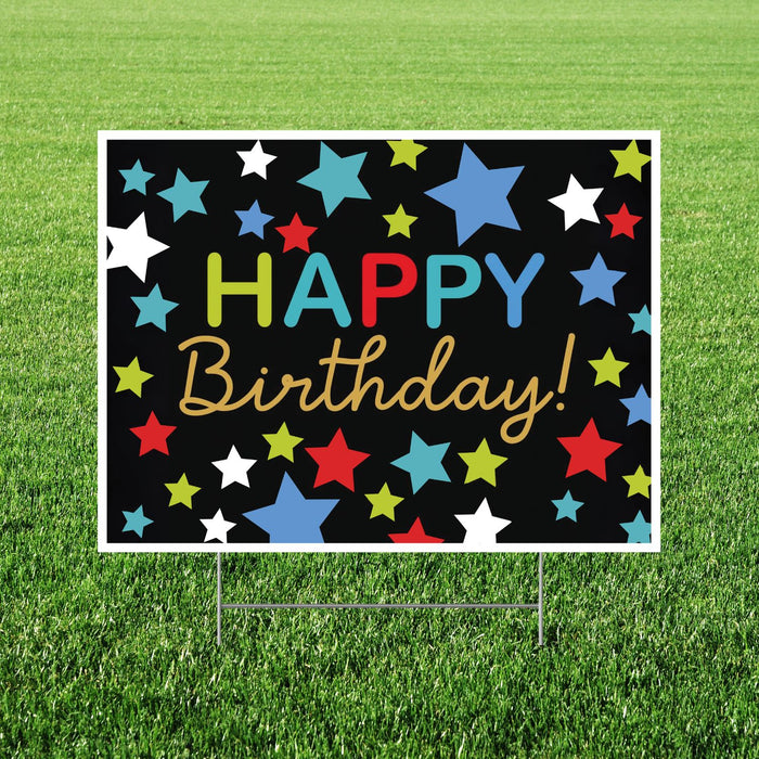 Colorful 'Happy Birthday!' sign with stars on a grass background