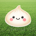 Large dumpling-shaped yard sign with a smiling face and pink cheeks, displayed on a lawn with an H stake stand.