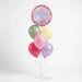 Amazing Mom balloon bouquet featuring a round floral “Amazing Mom” balloon with pastel green, yellow, pink, purple, and red latex balloons tied with curling ribbons.