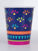 Boho fiesta paper cup featuring a navy background with colorful floral burst patterns, an orange dotted stripe, teal triangle border, green accent stripe, and hot pink bottom band.