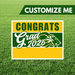 Graduation-themed customizable sign with 'Congrats Grad 2026' on a grass background