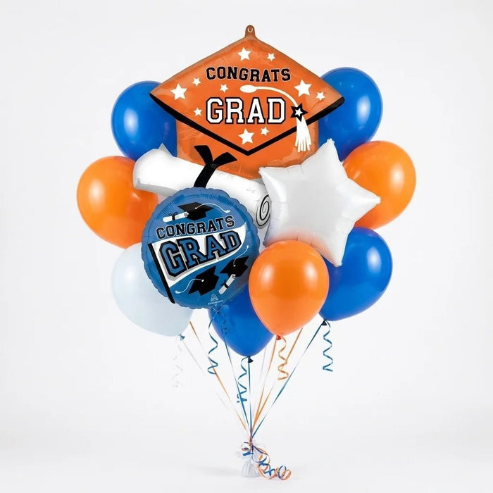 Graduation balloon bouquet featuring an orange “Congrats Grad” cap-shaped foil balloon, a blue round “Congrats Grad” foil balloon, a white star-shaped foil balloon, and blue, orange, and white latex balloons with curling ribbons.