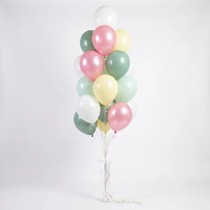 Balloon bouquet featuring pastel pearl pink, sage green, mint, pale yellow, and white latex balloons with curling ribbons.