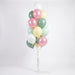 Balloon bouquet featuring pastel pearl pink, sage green, mint, pale yellow, and white latex balloons with curling ribbons.