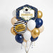 Graduation balloon bouquet featuring a navy and gold “Happy Graduation” foil balloon with white floral accents, a black-and-white striped “You’re Amazing” foil balloon, and navy, white, gold, and ivory latex balloons with curling ribbons.
