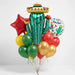 Fiesta cactus balloon bouquet featuring a smiling cactus-shaped foil balloon wearing a sombrero, a red star-shaped foil balloon, a round “Fiesta!” foil balloon, and red, yellow, green, and gold latex balloons with curling ribbons.