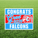 Graduation-themed sign with 'Congrats Grad 2026' and 'Falcons' on a grass background