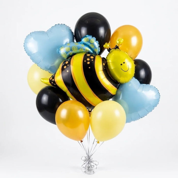 Bee balloon bouquet featuring a large smiling bee-shaped foil balloon, light blue heart-shaped foil balloons, and black, golden yellow, and pale yellow latex balloons.