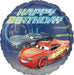 Alt text: Disney Cars birthday foil balloon featuring Lightning McQueen and Jackson Storm race cars on a blue racetrack-style background with large “Happy Birthday” lettering.
