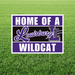 Sign with 'Home of a Louisburg Wildcat' text on a grass background