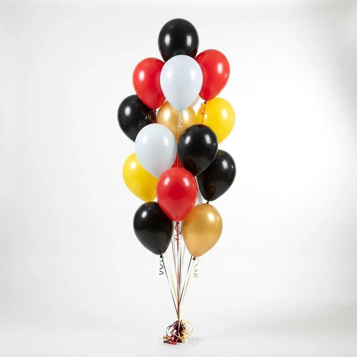 Balloon bouquet featuring black, red, yellow, gold, and white latex balloons with curling ribbons.