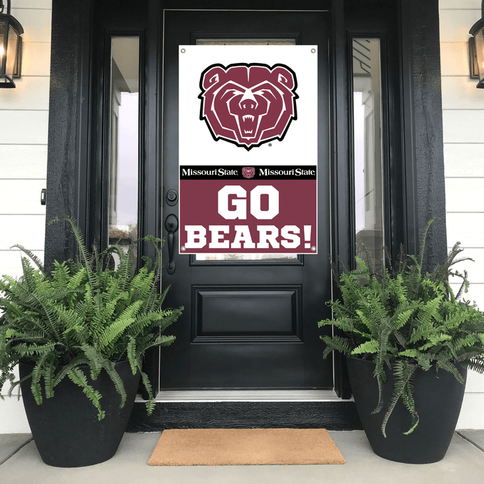 Black door with a Missouri State 'Go Bears!' sign flanked by potted ferns on a porch.
