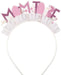 Mom-to-be headband featuring pink floral “Mom to be” lettering with white fringe accents on a white headband.