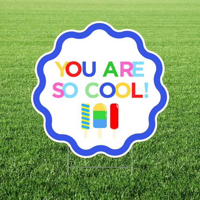 "You Are So Cool" yard sign featuring colorful lettering, popsicle graphics, and a blue scalloped border on a white cutout sign displayed in grass.