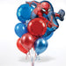 Spider-Man balloon bouquet featuring a large Spider-Man action pose foil balloon, red and blue round foil balloons, and red, blue, metallic red, and metallic blue latex balloons with curling ribbons.