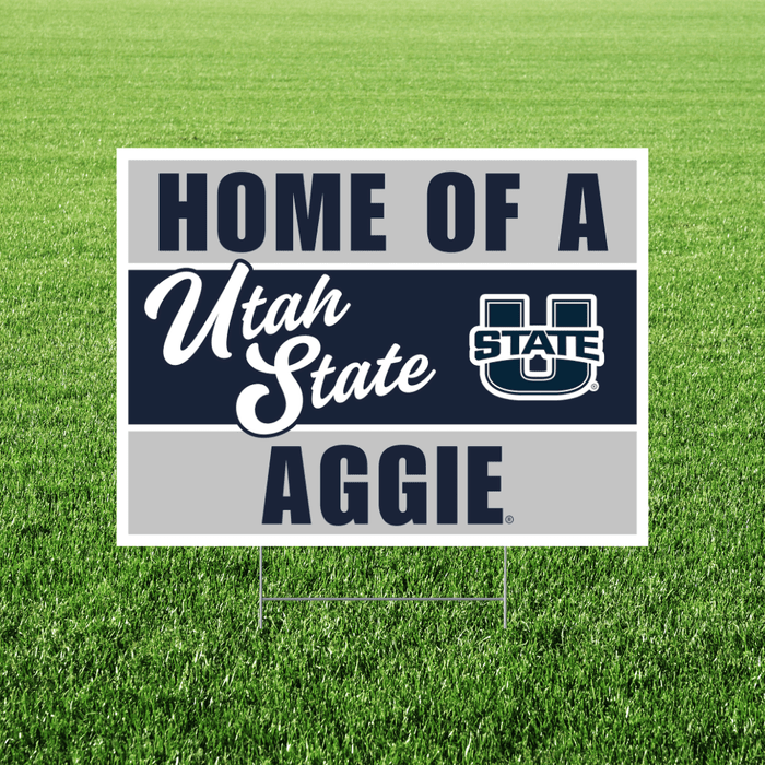 Sign with 'Home of a Utah State Aggie' text and logo on grass