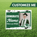 Graduation-themed customizable sign with a photo of a graduate on a grass background